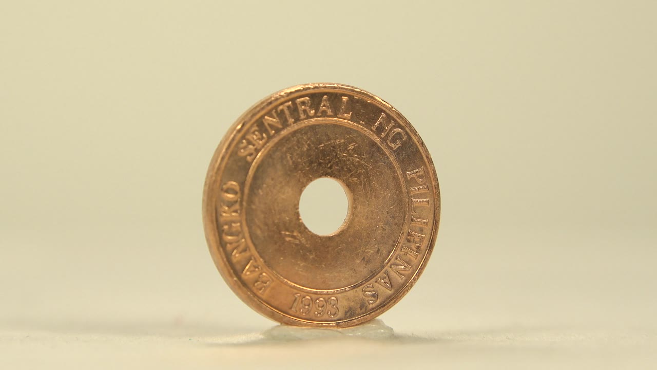 Close front view of a coin marked Central Bank of the Philippines.