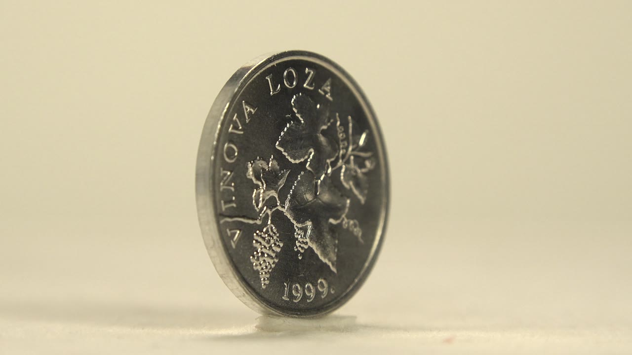 Silver coin face showing grapevine design and 1999 date.
