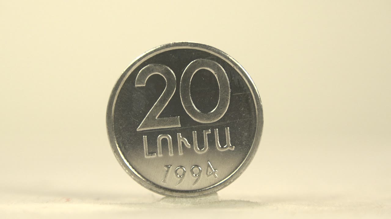 Close front view of a silver 20 coin.