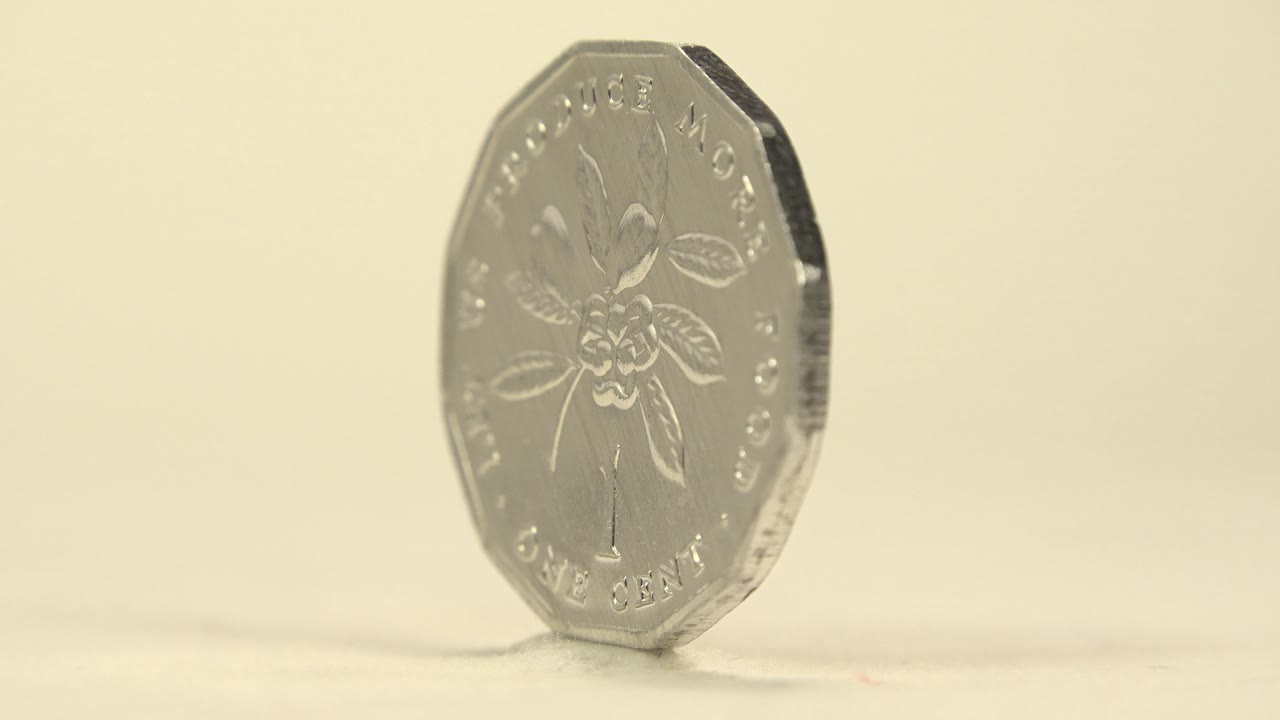 Rotating Jamaican coin angled on its edge