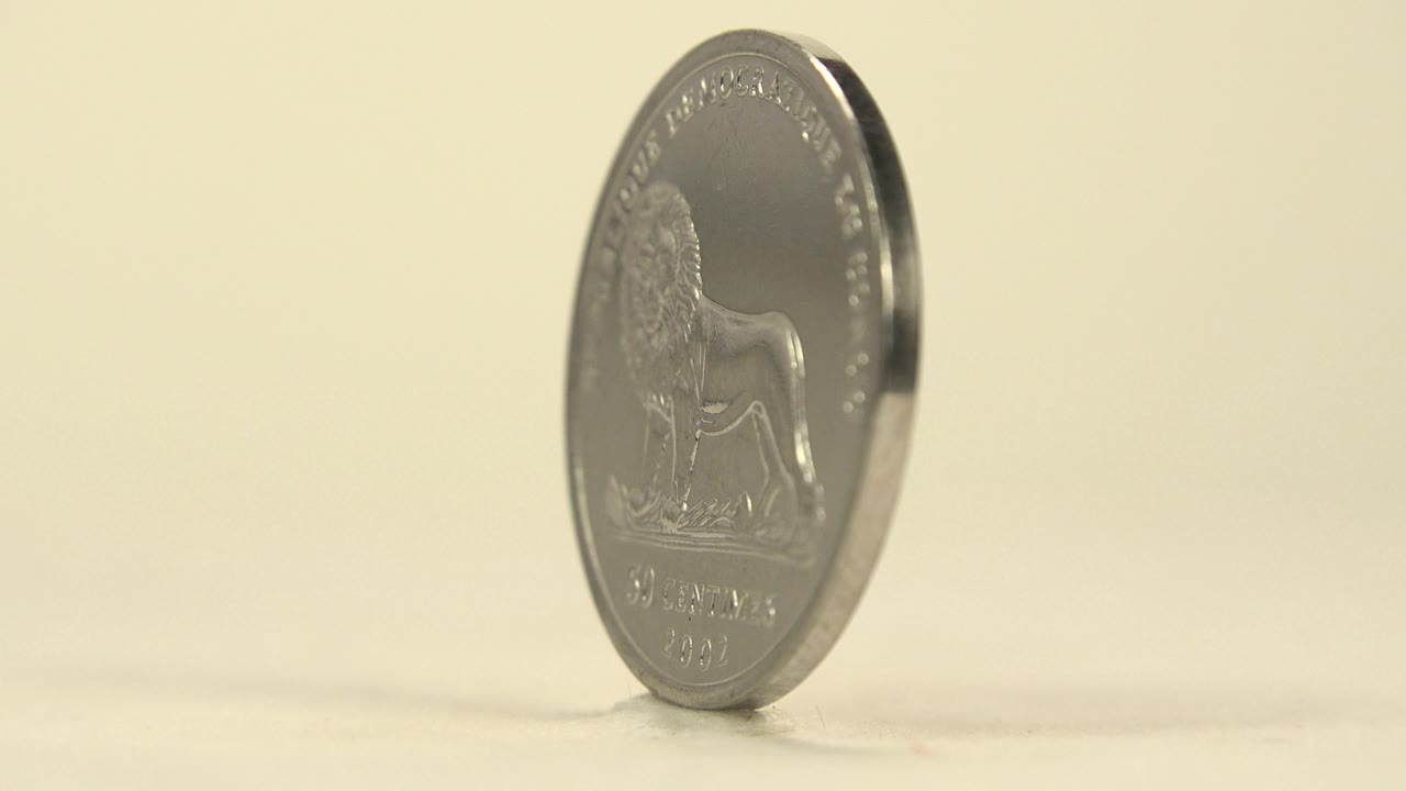 Coin angled partly sideways with the lion side fading from view.