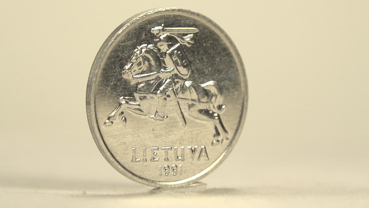 The coin faces the camera with a raised horse rider emblem, LIETUVA text, and 1991 date visible against the cream background with no visible people.