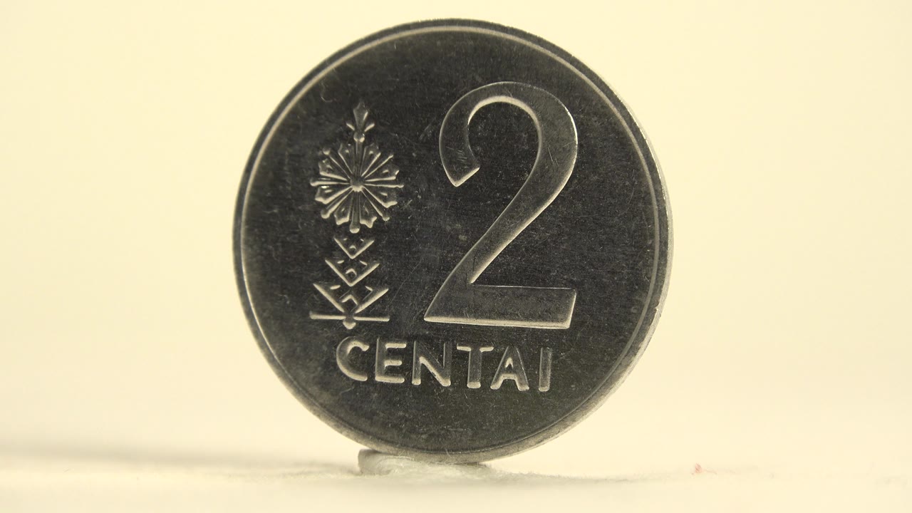A darker face-on view of the same upright 2 CENTAI coin shows stronger shadow on the metal and no visible people.