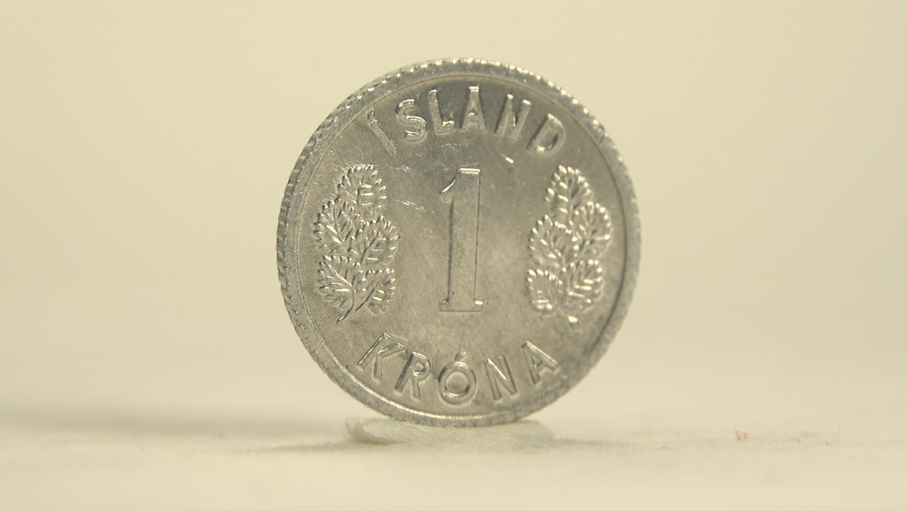 Front of a silver coin marked Island Krona and 1.