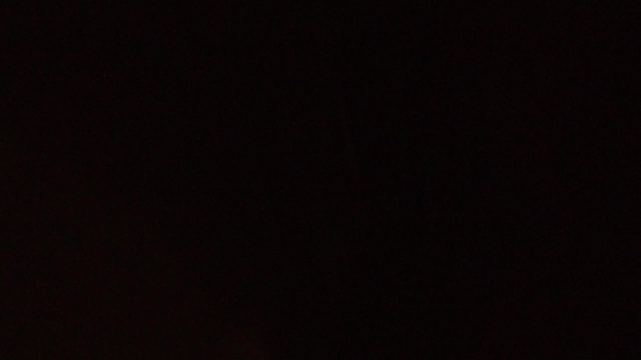 Second frame remains almost entirely black, with slight reddish tonal variation and no visible people or readable objects in the Winter Park Colorado clip.