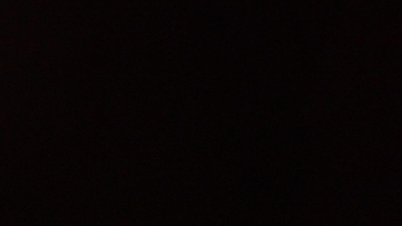 Very dark interior with a faint warm patch of light