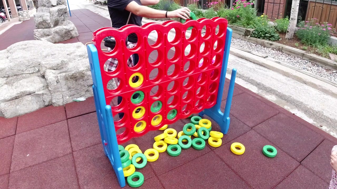 Large red and blue game board with yellow and green rings on rubber tiles.