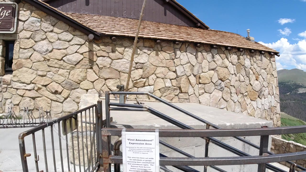 Stone building exterior with railings and a posted sign