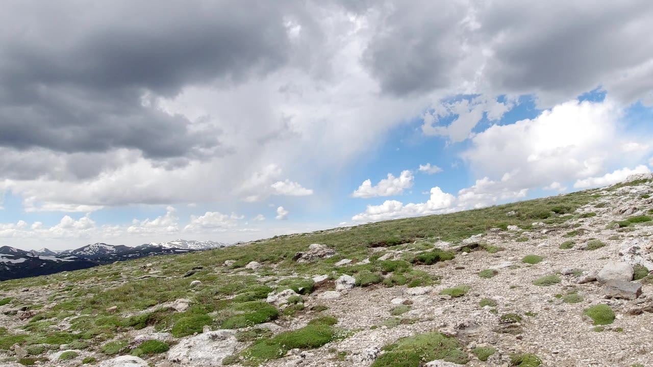 Rocky mountain slope under heavy clouds