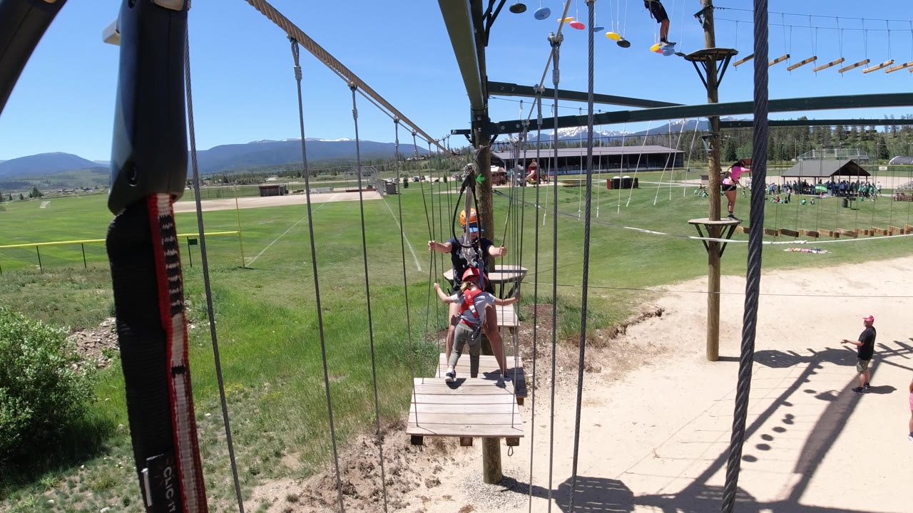 Adult and child on a suspended ropes-course platform