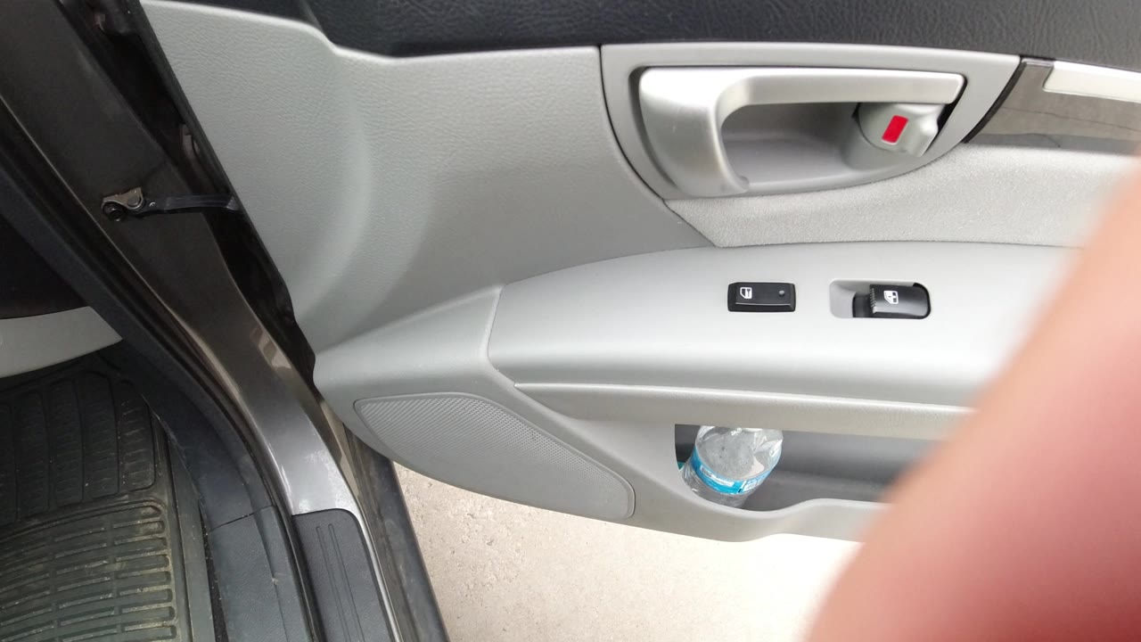At 0:01 in Winter Park, Colorado, the same open gray car door remains in view while a blurred fingertip begins to intrude along the right edge of the frame.