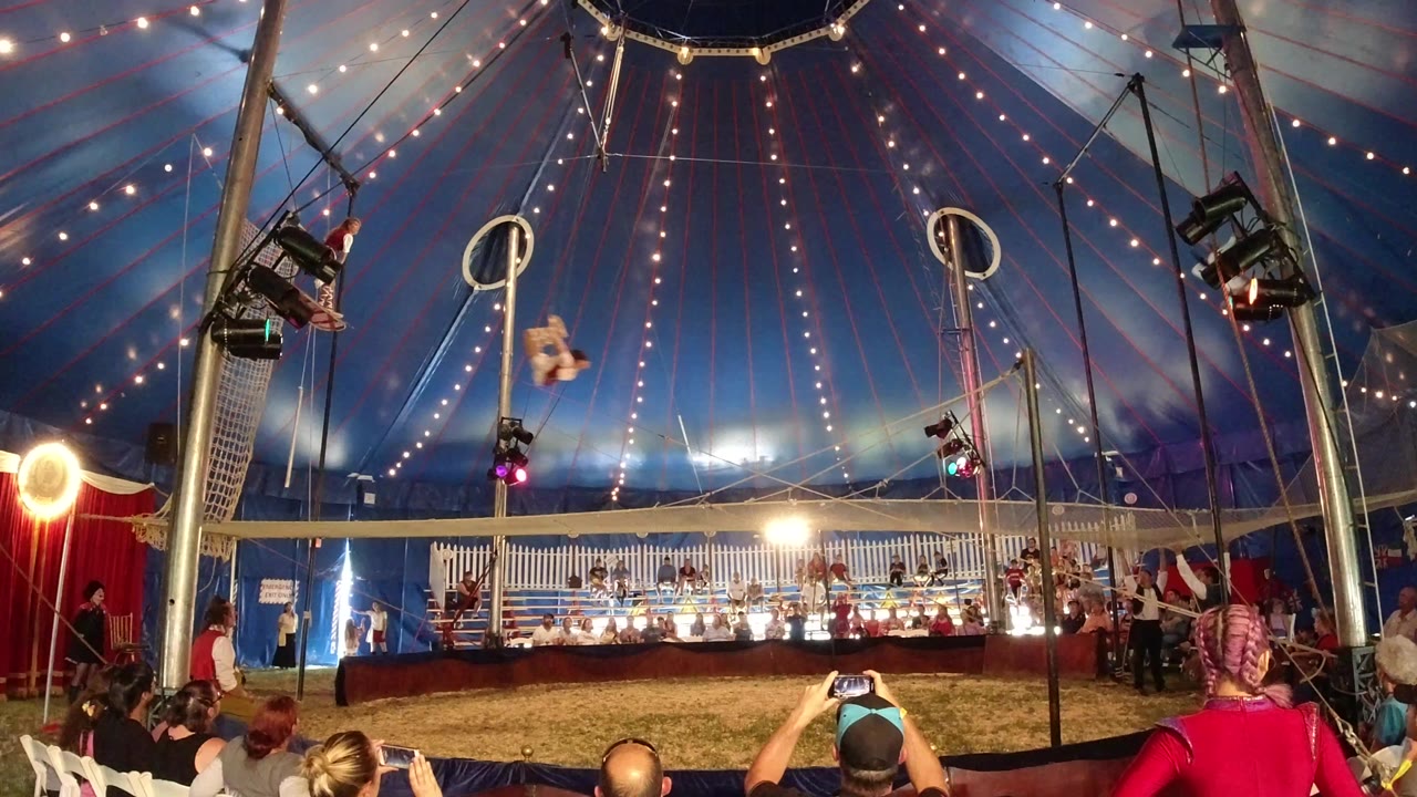 Wide view of circus tent with aerial apparatus and audience