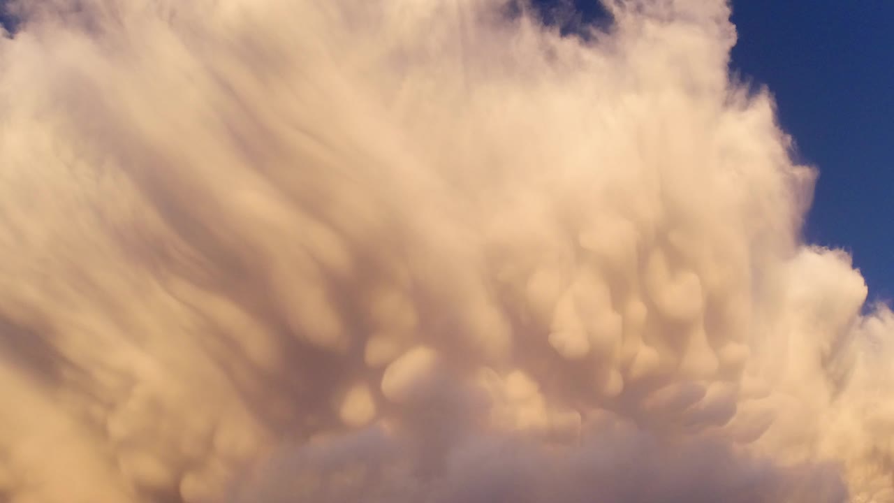 A large yellow-orange cloud fills the Broomfield, Colorado sky with a small wedge of blue sky visible at upper right and no visible people.
