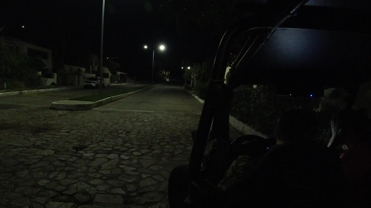 Low-light cart-mounted view of a quiet street