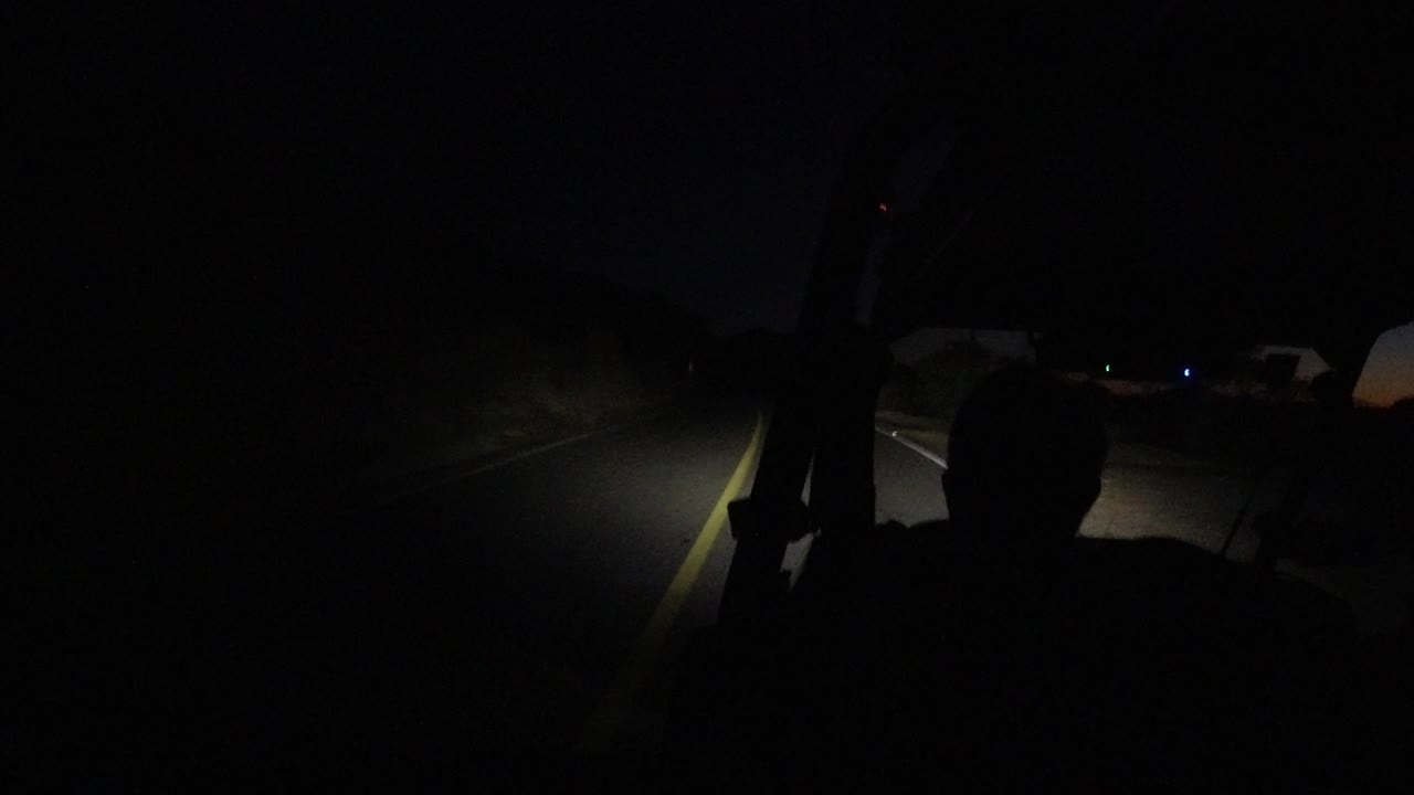 Headlights illuminate lane markings in darkness