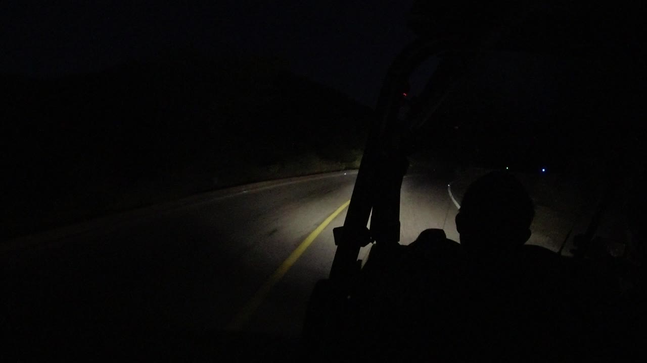Empty road curve with yellow center line in darkness