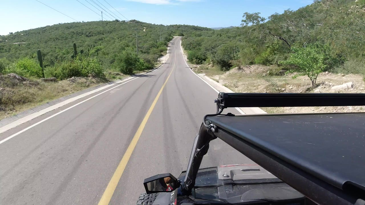 Two-lane road ahead with Jeep roof hardware in foreground