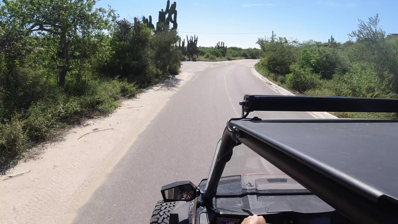 Vehicle POV approaching a wider bend in a quiet roadside area