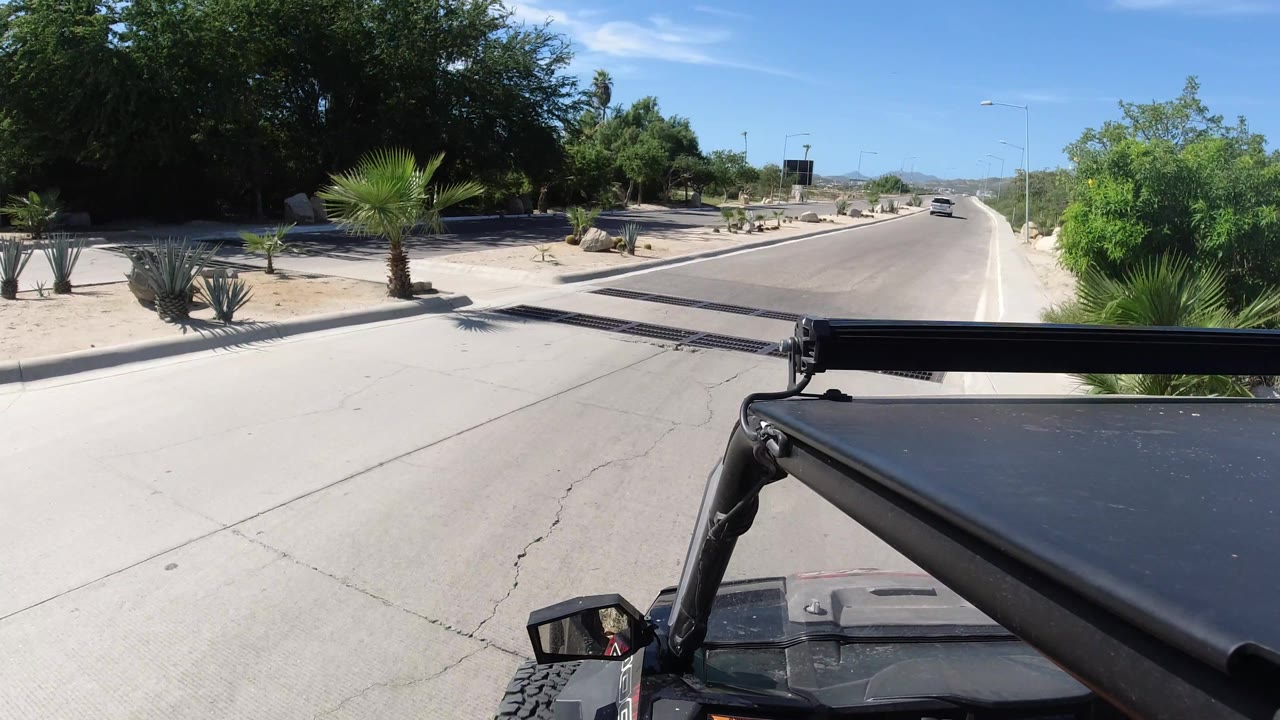 Forward road view with the Wrangler foreground and a distant car.
