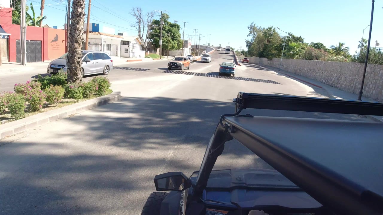 Jeep roof foreground on a sunny road with cars ahead