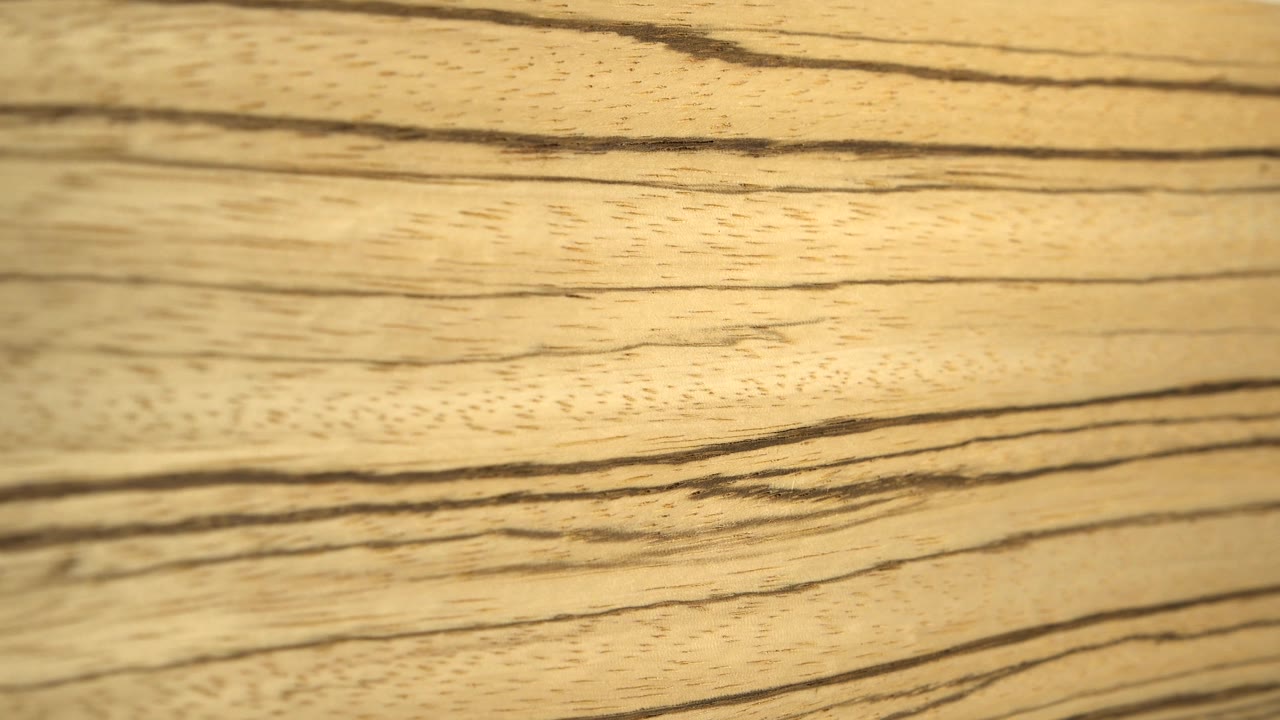 Close view of pale wood grain running horizontally across the frame.