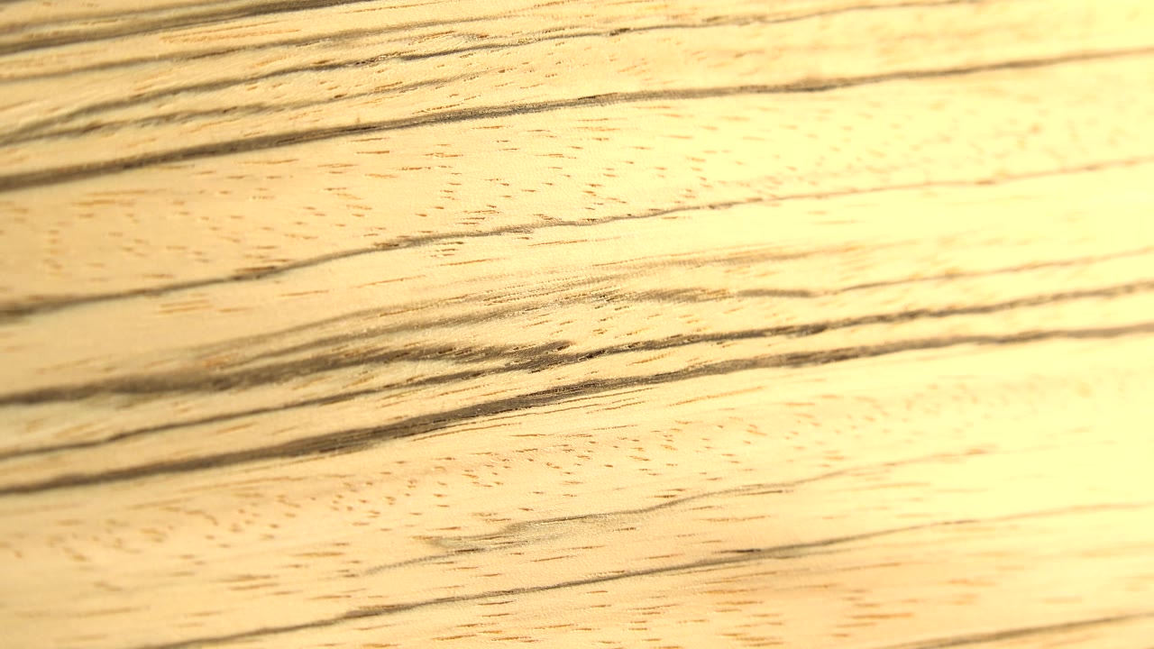 The yellow object appears slightly shifted, with black stripe bands running diagonally across the close-up and no visible people.