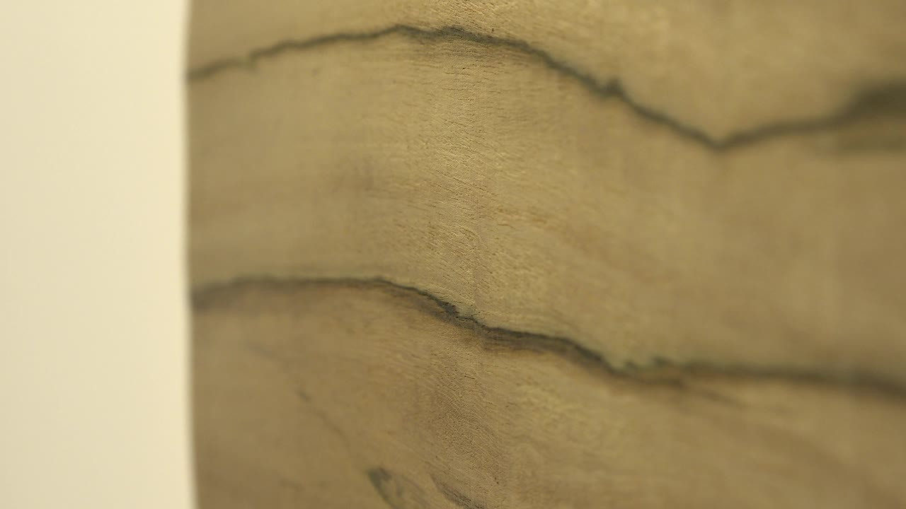 Wooden surface beside a pale vertical edge.