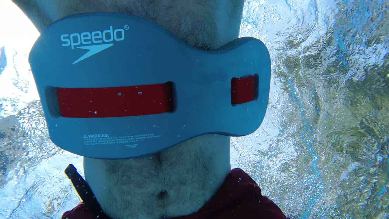 Underwater view of swimmer wearing blue flotation belt