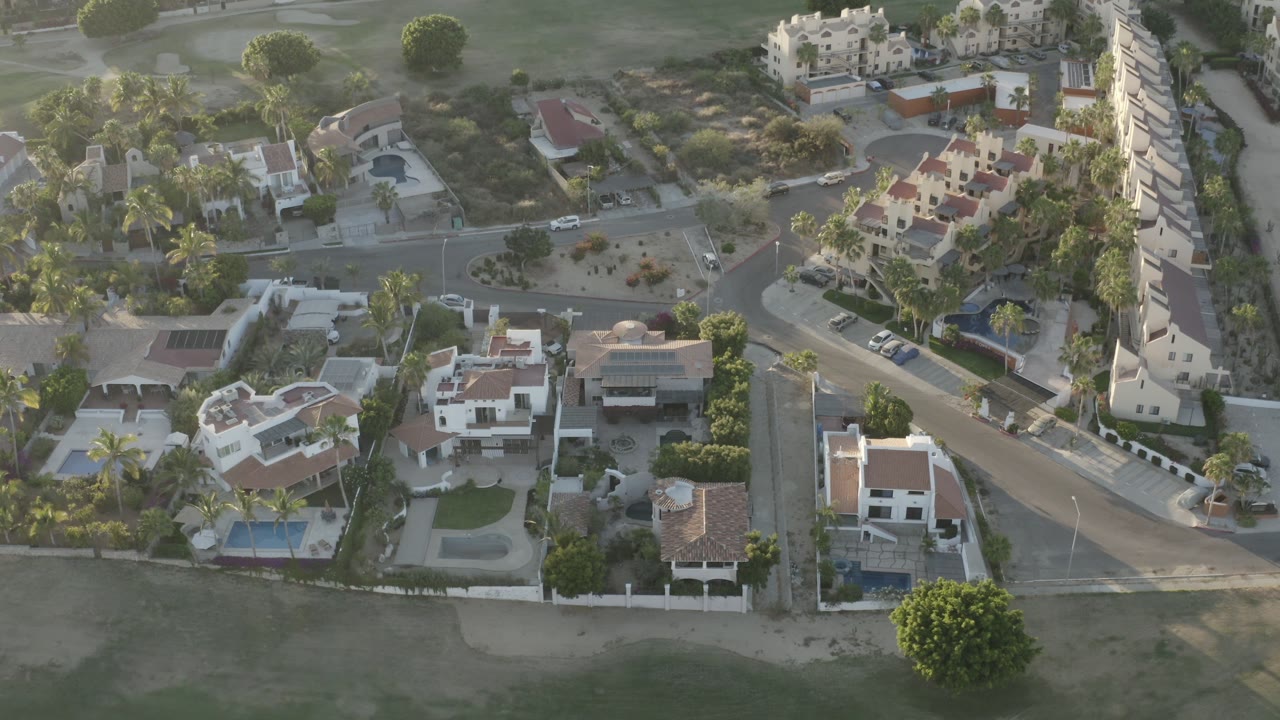 Aerial view of homes, yards, and a curving road.