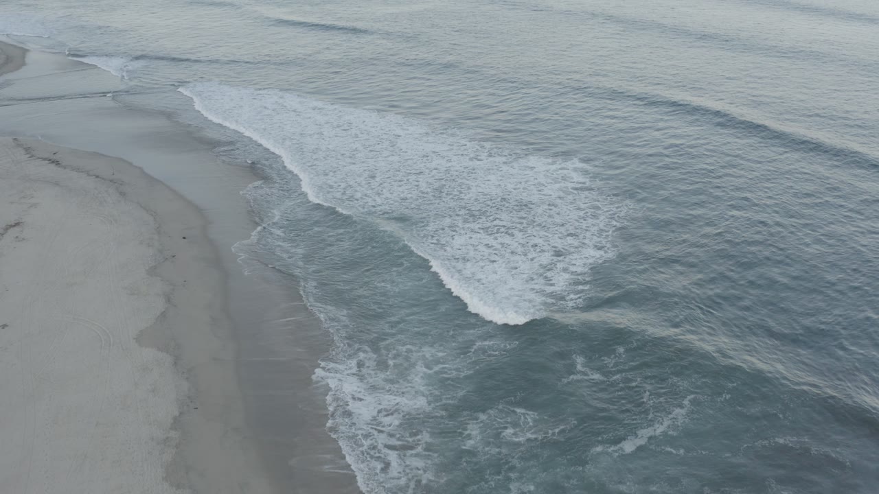 Wide overhead view of surf bands and shoreline.