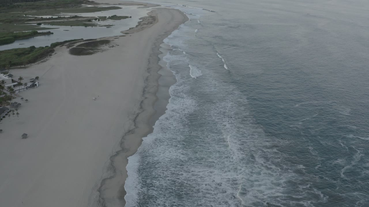 Aerial beach coastline with foam bands and open water