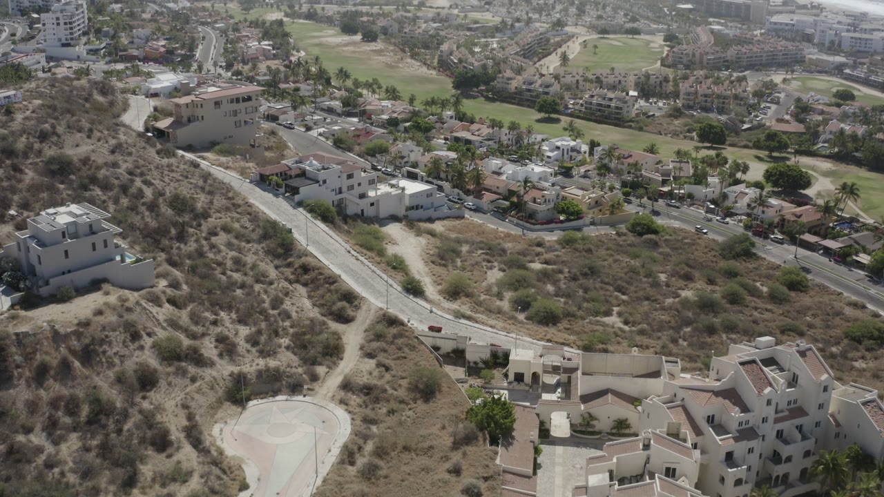 Elevated view of hillside homes and a winding road