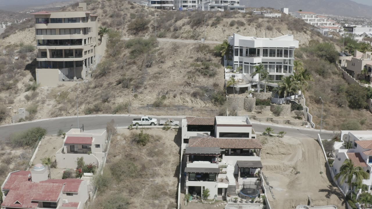 Elevated view of hillside homes beside a curved road