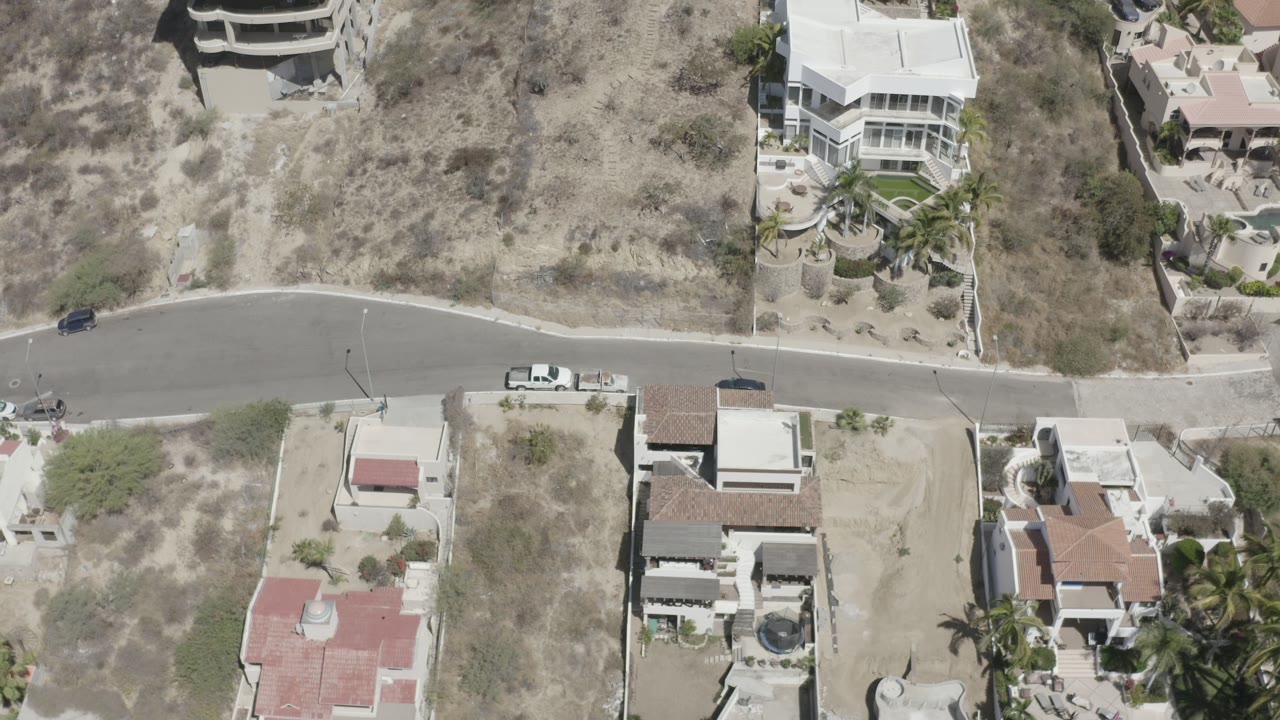 Vacant land and luxury homes seen from directly above.