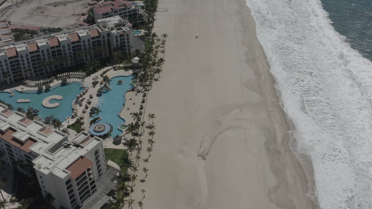 Resort roofs, pool, beach, and surf line