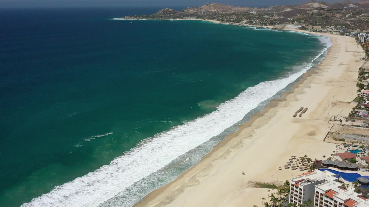 Long beach and green-blue water seen from above