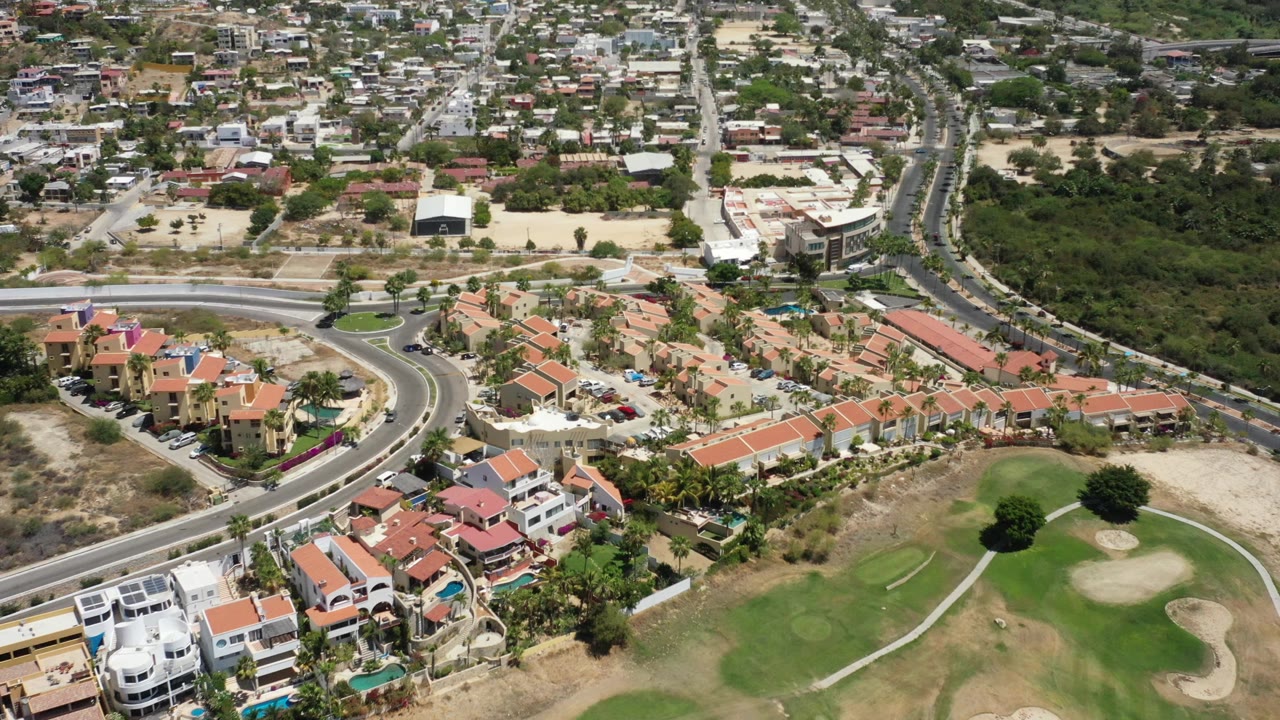 High aerial of a residential estate next to a golf fairway.
