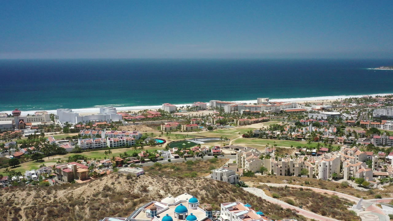 Aerial view of coastal town, beach, and blue ocean