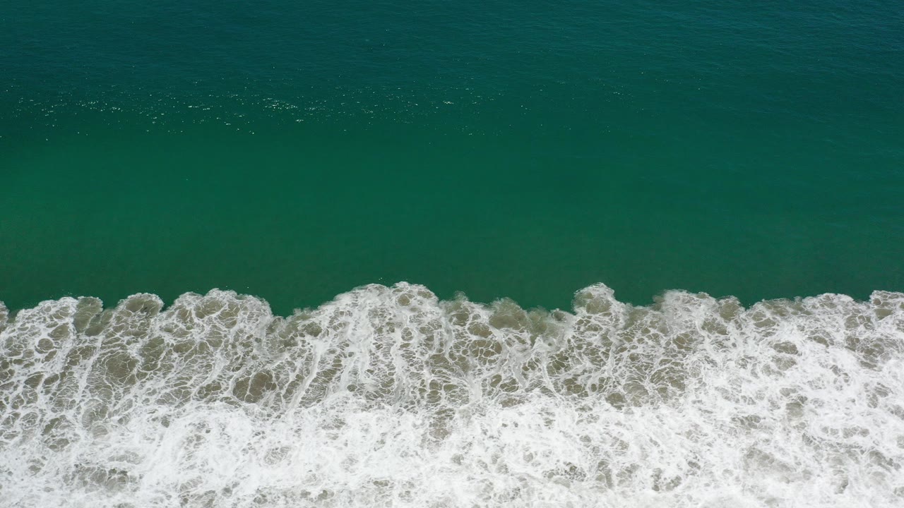 Overhead green ocean with a white surf band