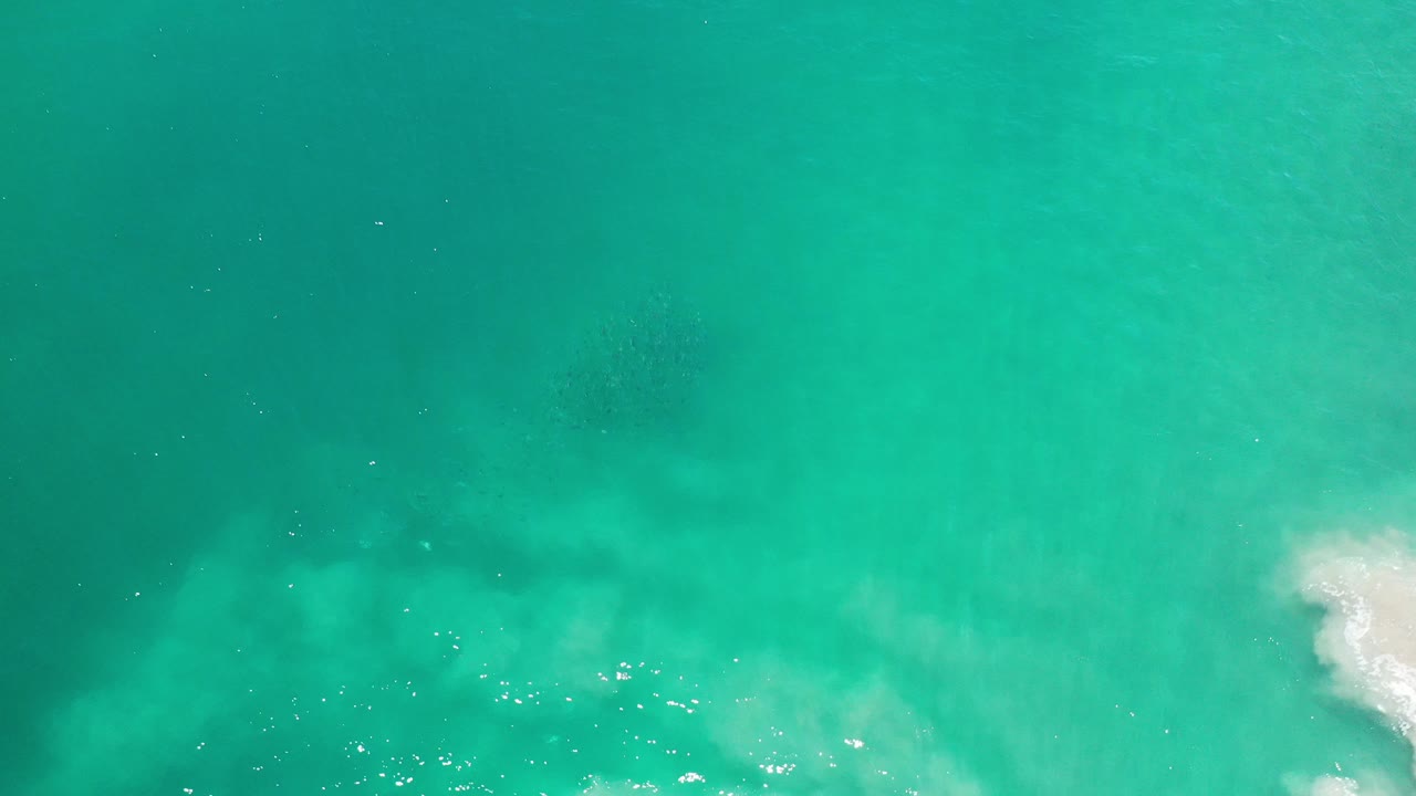 Overhead turquoise seawater with pale surf texture