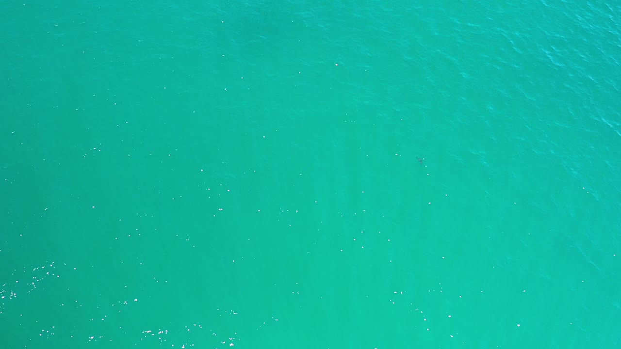 Aqua water surface with faint ripples.
