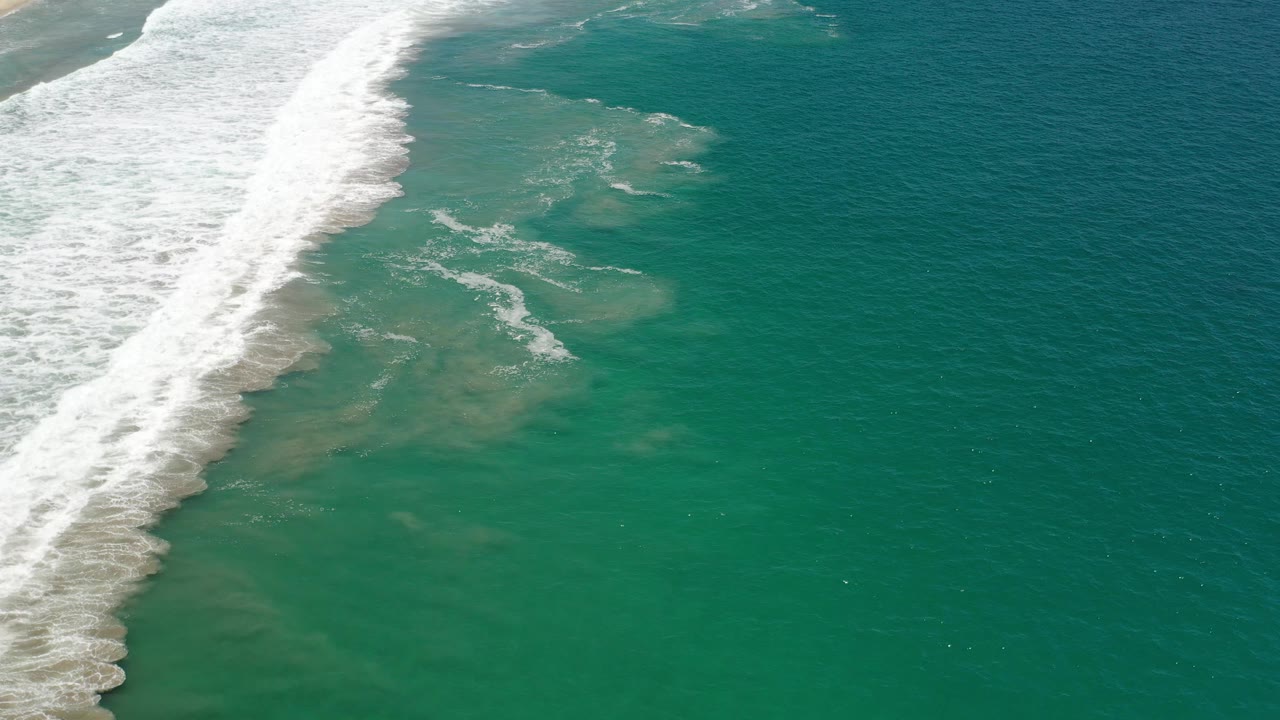 Surf line and clear ocean water seen from above.