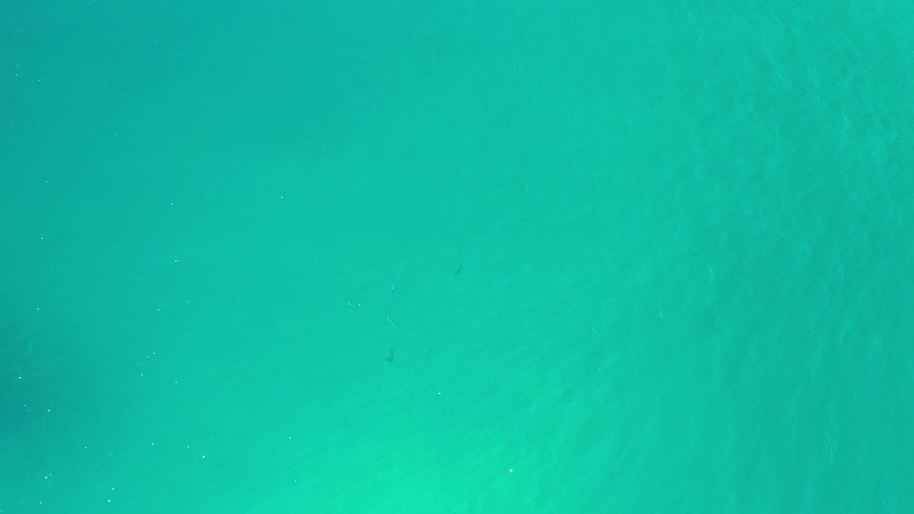 Aqua water surface with muted darker areas.