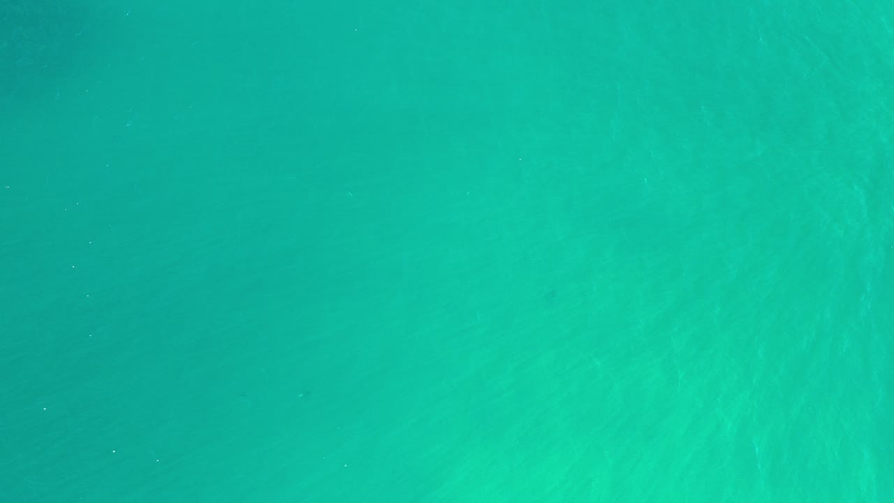 Overhead view of turquoise sea water in Los Cabos, Mexico, with faint surface ripples and no visible people.