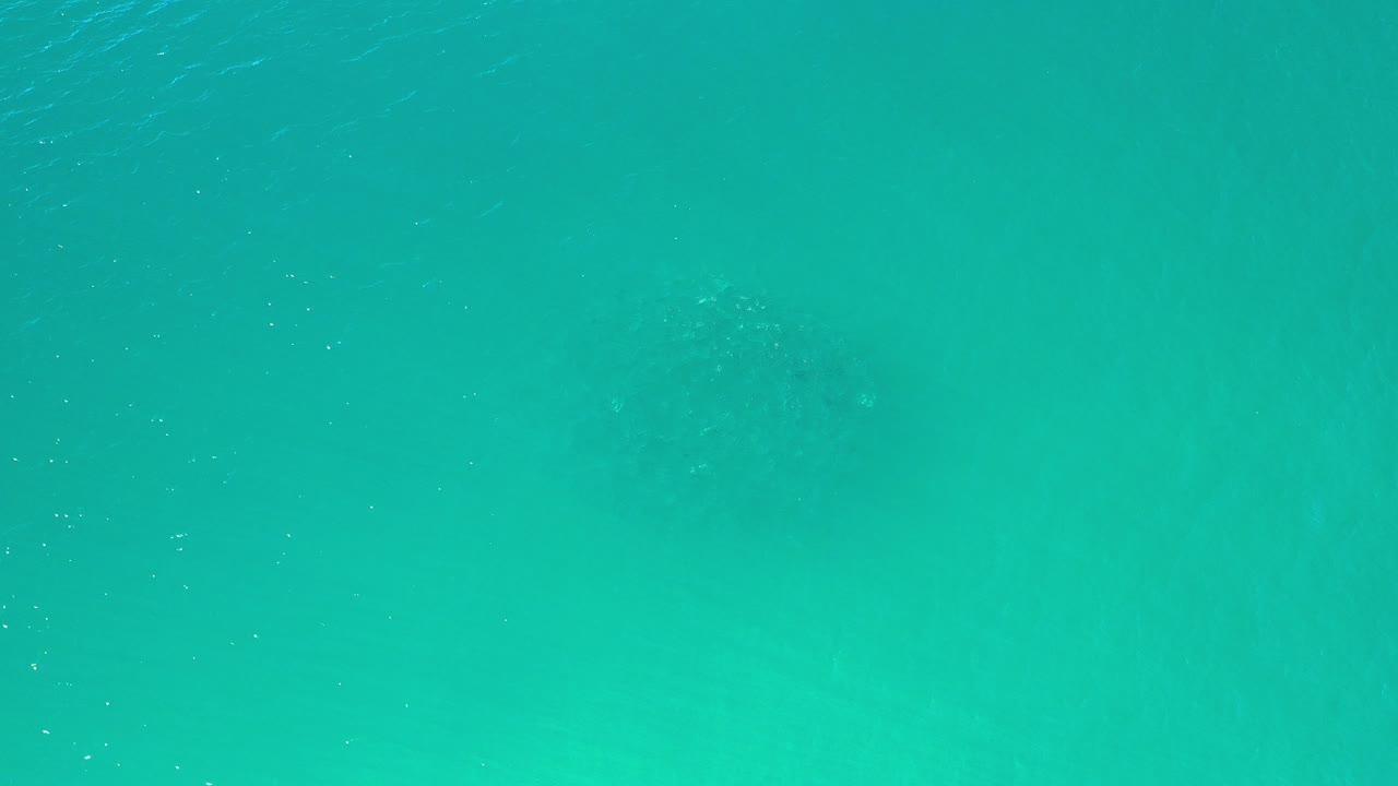 Teal ocean surface seen from above.