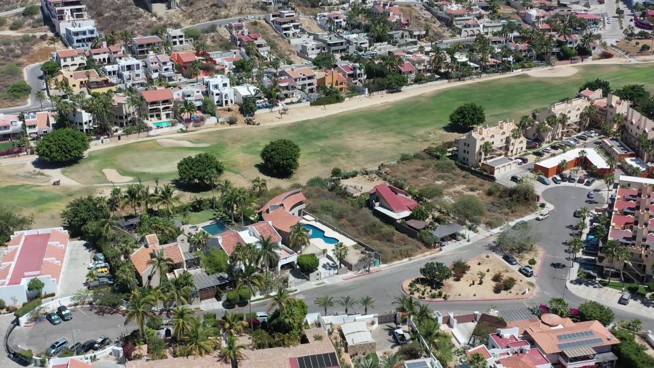 Hillside residential blocks overlook a golf-course fairway and streets.