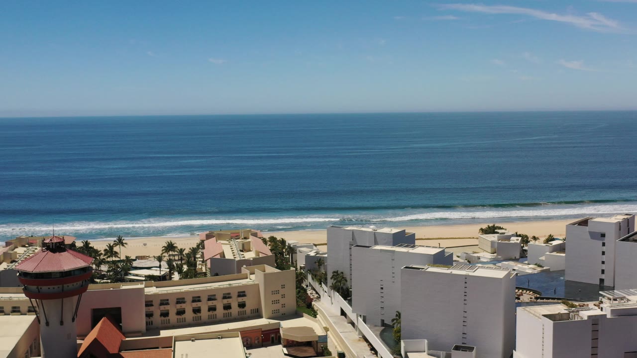 Beachfront buildings below a wide blue ocean view.