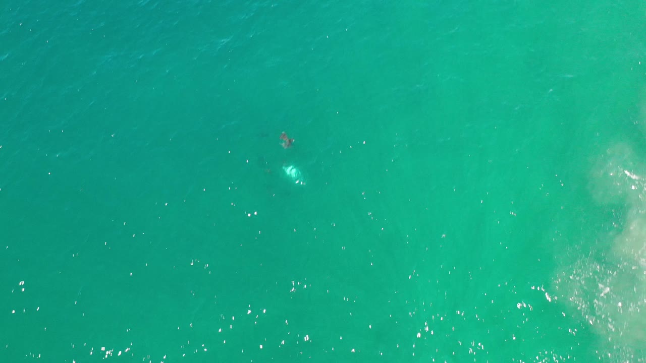 Aquamarine water with a pale cloudy patch at the right edge.