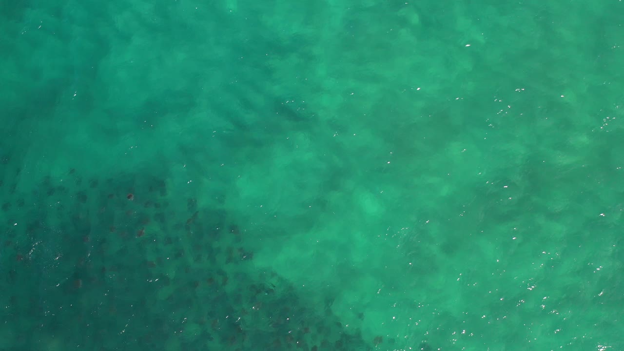 Turquoise-green ocean water seen from above