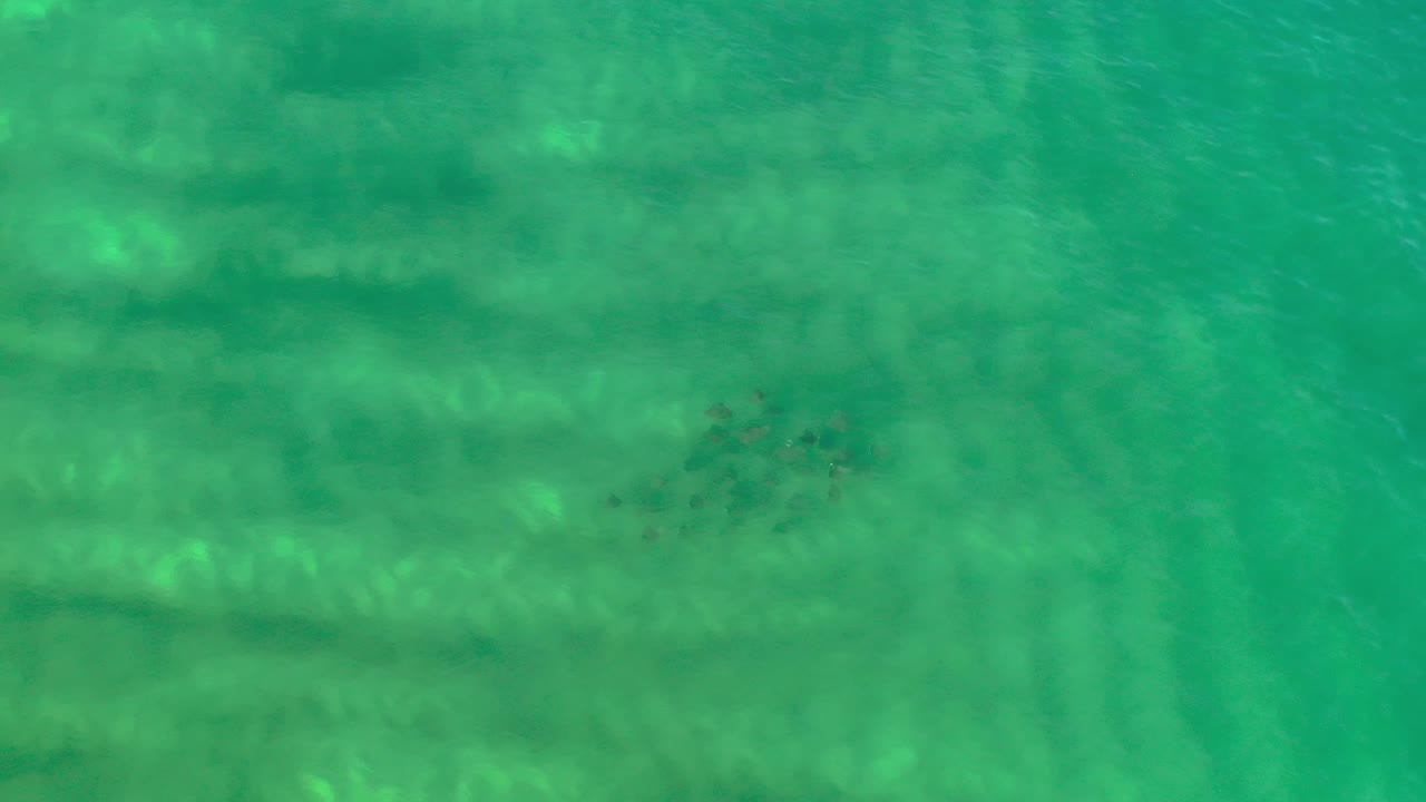 Clear green ocean water with pale bands beneath